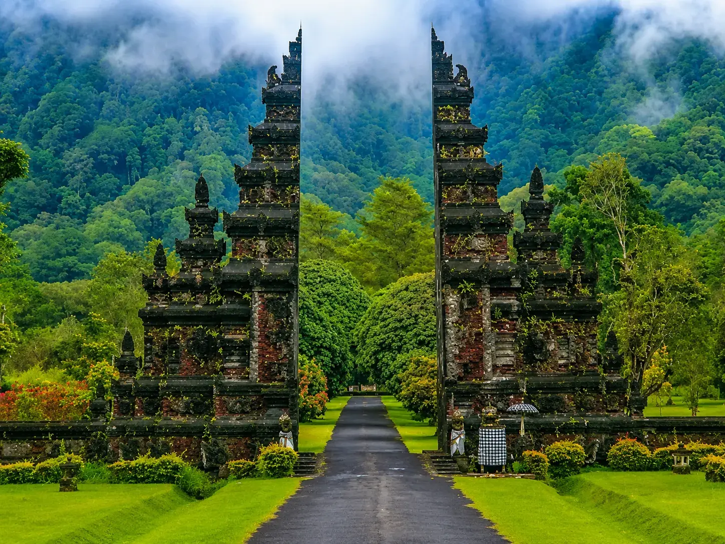 Balinese temple gate surrounded by lush green mountains in Bali