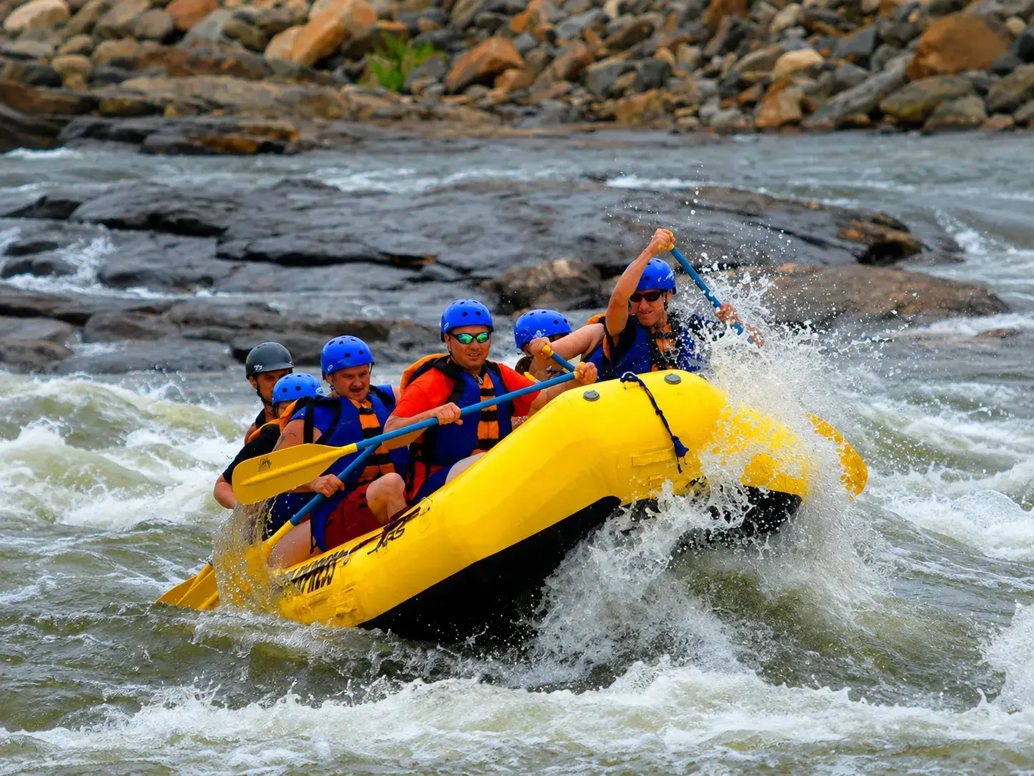 Group enjoying white-water river rafting adventure